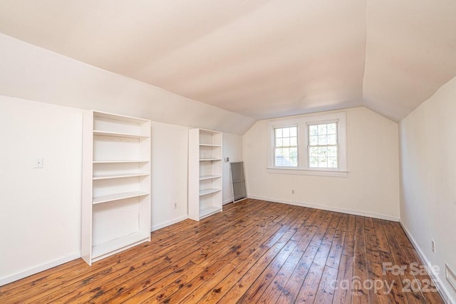 bonus room with wood-type flooring and lofted ceiling