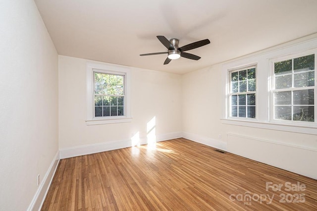 spare room featuring ceiling fan and light hardwood / wood-style flooring