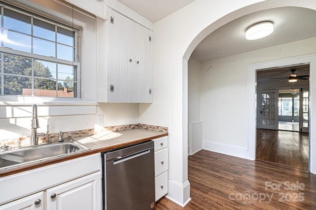 kitchen featuring white cabinets, dishwasher, sink, dark hardwood / wood-style floors, and tile countertops