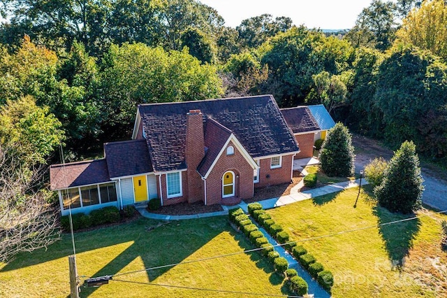 exterior space with a front lawn and a sunroom