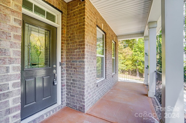 view of exterior entry with a porch