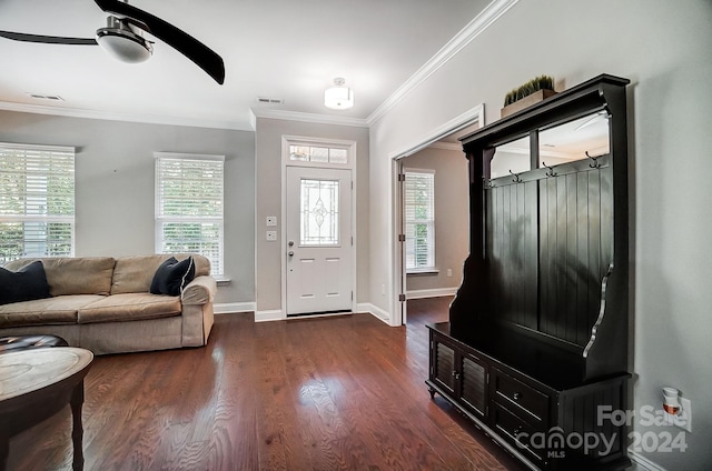 foyer entrance featuring dark wood-type flooring, crown molding, and ceiling fan