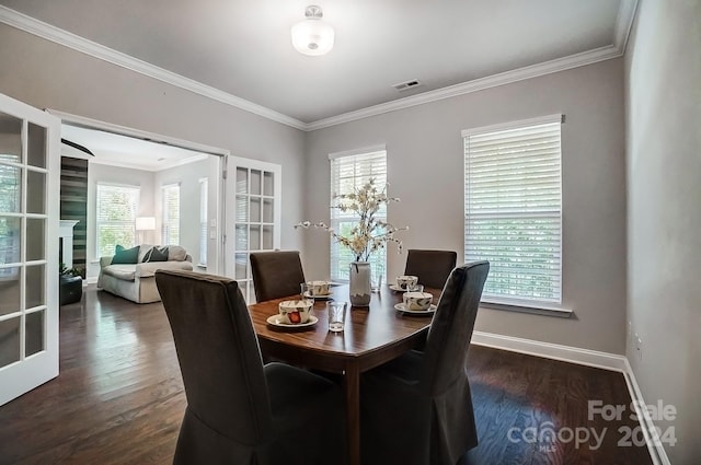 dining room featuring crown molding, french doors, and dark wood-type flooring