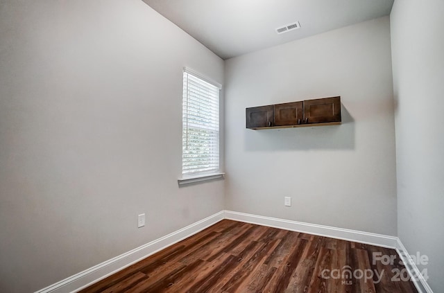 spare room with dark hardwood / wood-style flooring