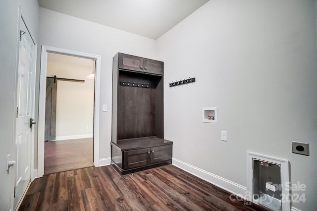 mudroom featuring a barn door and dark hardwood / wood-style floors