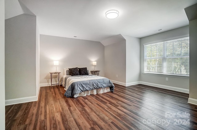 bedroom featuring vaulted ceiling and dark hardwood / wood-style floors