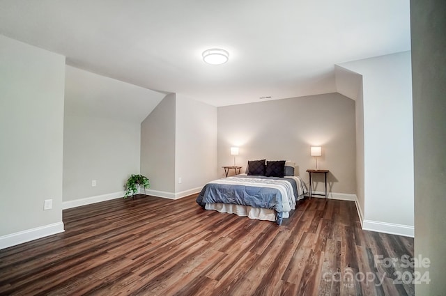 bedroom with dark wood-type flooring and vaulted ceiling