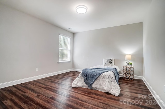 bedroom featuring dark wood-type flooring