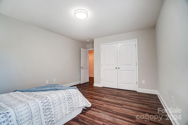 bedroom with a closet and dark hardwood / wood-style flooring