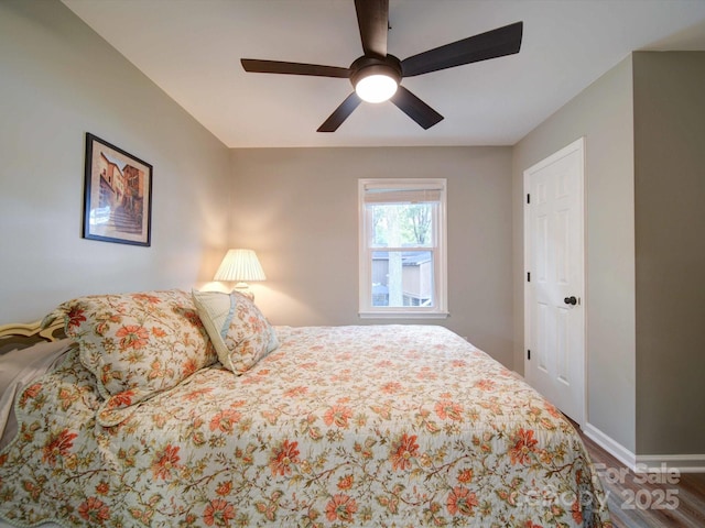 bedroom with ceiling fan, baseboards, and wood finished floors