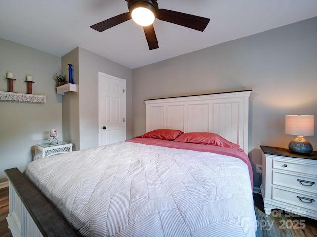 bedroom featuring ceiling fan and dark wood-type flooring