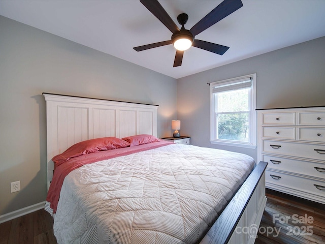 bedroom featuring dark wood finished floors, a ceiling fan, and baseboards