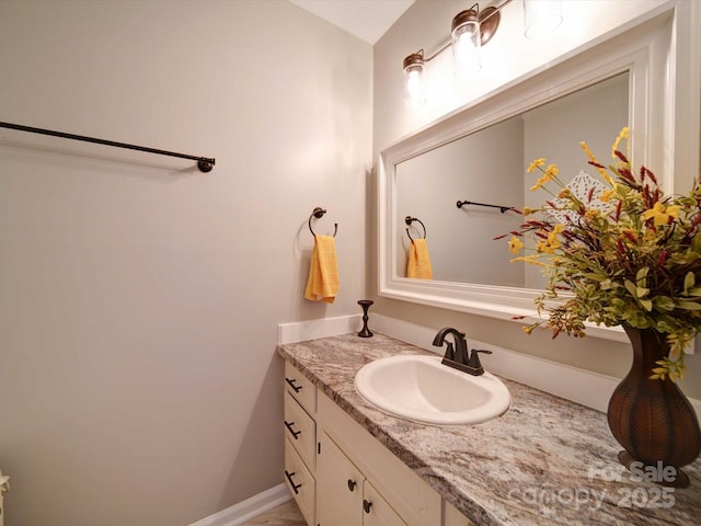 bathroom with baseboards and vanity