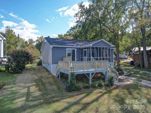 back of property featuring a yard, crawl space, a sunroom, a wooden deck, and stairs