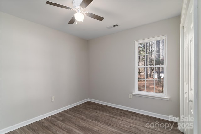 unfurnished room featuring dark hardwood / wood-style floors and ceiling fan