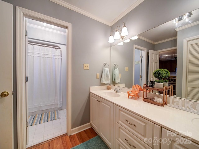 bathroom featuring baseboards, wood finished floors, curtained shower, crown molding, and vanity