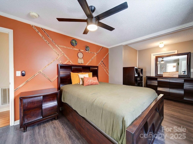 bedroom featuring dark wood-type flooring, visible vents, crown molding, and a textured ceiling