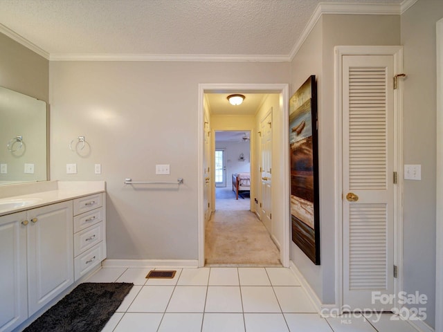 bathroom featuring ornamental molding, a textured ceiling, and tile patterned floors