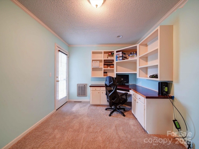 office featuring ornamental molding, light colored carpet, a textured ceiling, and baseboards