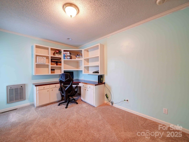 office area with crown molding, built in desk, and baseboards