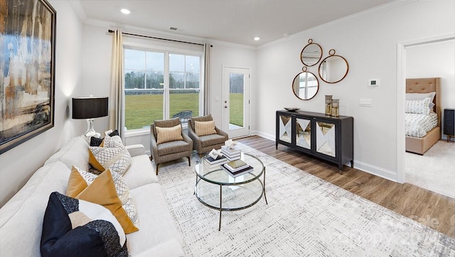 living room featuring hardwood / wood-style floors and crown molding