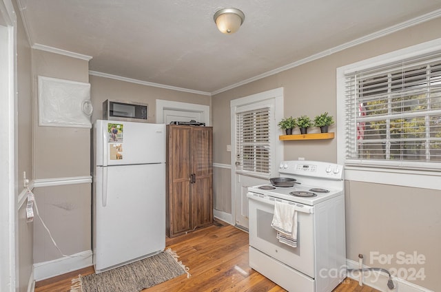 kitchen featuring white appliances, crown molding, and light wood-type flooring