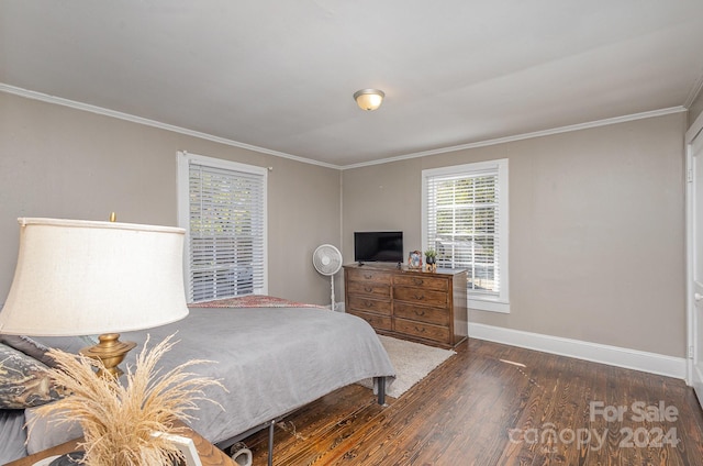 bedroom with crown molding and dark hardwood / wood-style floors