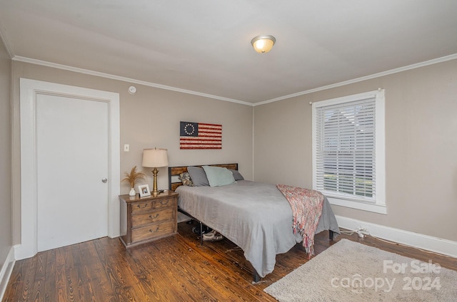 bedroom with ornamental molding and dark hardwood / wood-style flooring