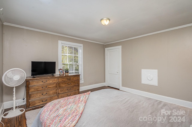 bedroom with crown molding and hardwood / wood-style flooring