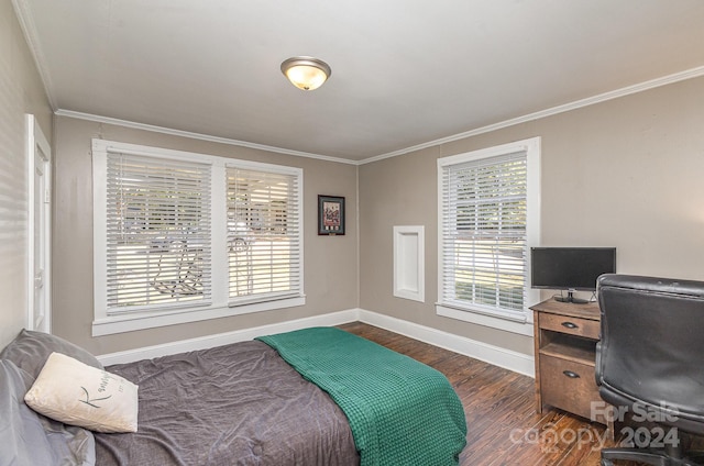 bedroom with crown molding and dark hardwood / wood-style flooring