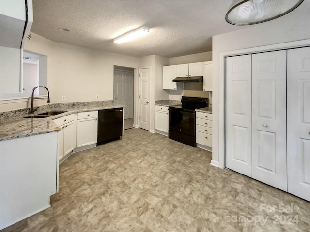 kitchen with sink, black appliances, white cabinets, and a textured ceiling