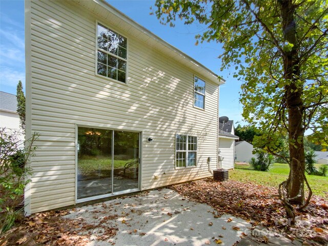 rear view of house featuring central AC and a patio area