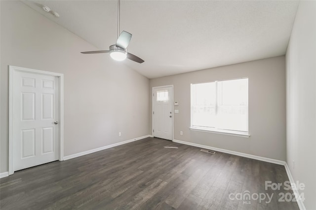 entryway with ceiling fan, a textured ceiling, lofted ceiling, and dark hardwood / wood-style floors