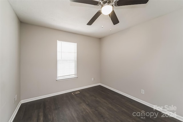 spare room featuring dark hardwood / wood-style floors and ceiling fan