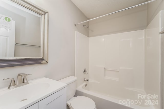 full bathroom featuring toilet, a textured ceiling, vanity, and shower / bathtub combination