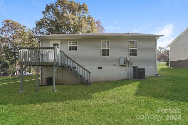 back of house featuring a deck and a lawn