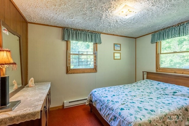 carpeted bedroom featuring a baseboard radiator, a textured ceiling, multiple windows, and ornamental molding