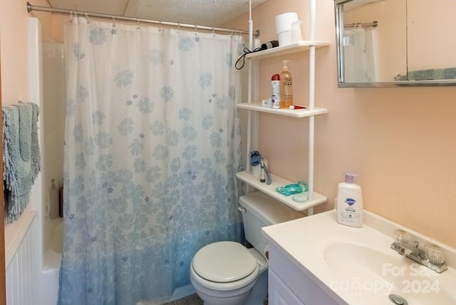 full bathroom featuring shower / tub combo with curtain, vanity, a textured ceiling, and toilet