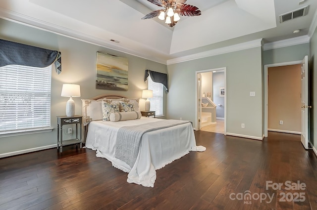 bedroom with a tray ceiling, ceiling fan, ensuite bathroom, and dark hardwood / wood-style floors