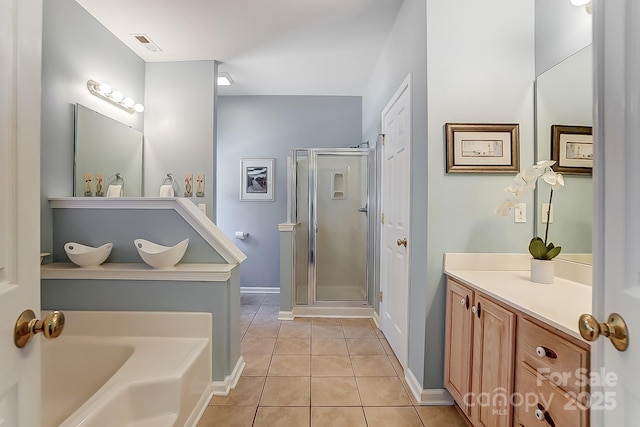 bathroom with tile patterned floors, vanity, and shower with separate bathtub