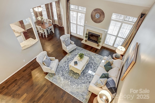 living room with a healthy amount of sunlight, dark hardwood / wood-style flooring, and a fireplace