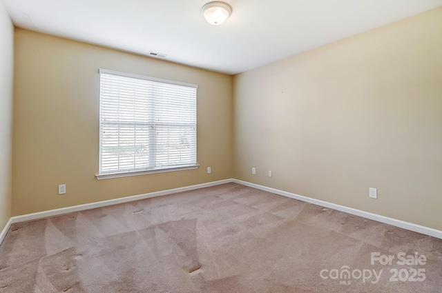 empty room featuring light carpet