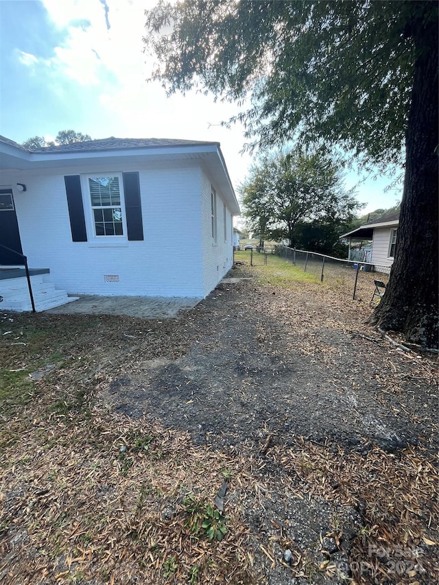 560 2nd St, Chester, SC 29706 - view of property exterior with brick siding, crawl space, and fence