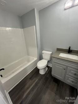 560 2nd St, Chester, SC 29706 - full bath featuring toilet, vanity, bathtub / shower combination, and wood finished floors