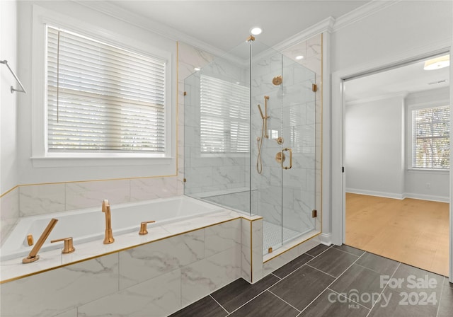 bathroom featuring crown molding, a healthy amount of sunlight, and plus walk in shower