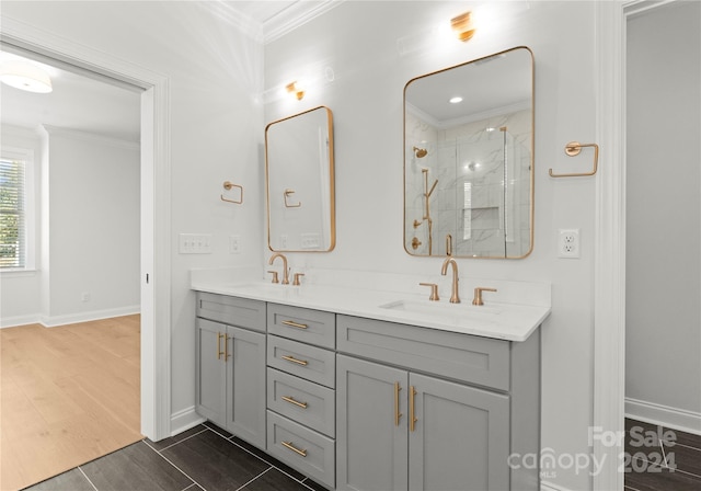 bathroom featuring a shower with door, vanity, ornamental molding, and hardwood / wood-style flooring