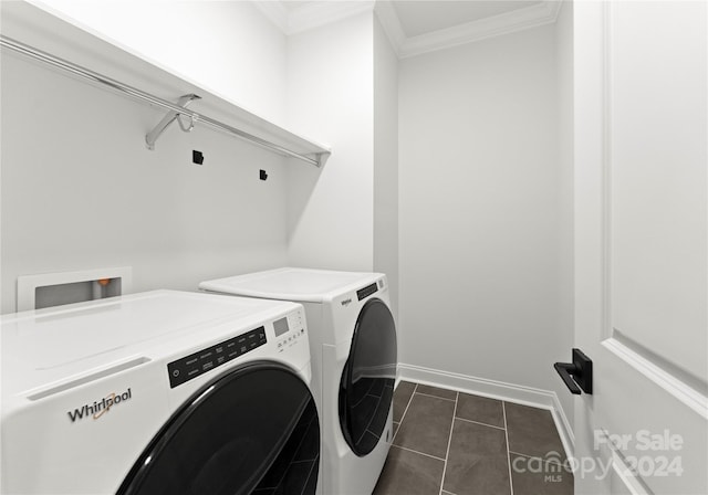 washroom with dark tile patterned floors, ornamental molding, and independent washer and dryer