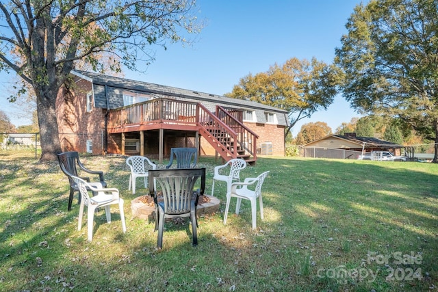 back of property featuring a wooden deck and a yard