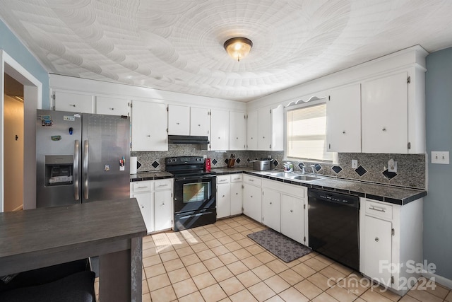 kitchen with sink, black appliances, white cabinets, and backsplash