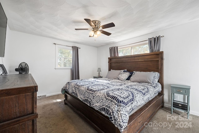 bedroom with dark colored carpet and ceiling fan